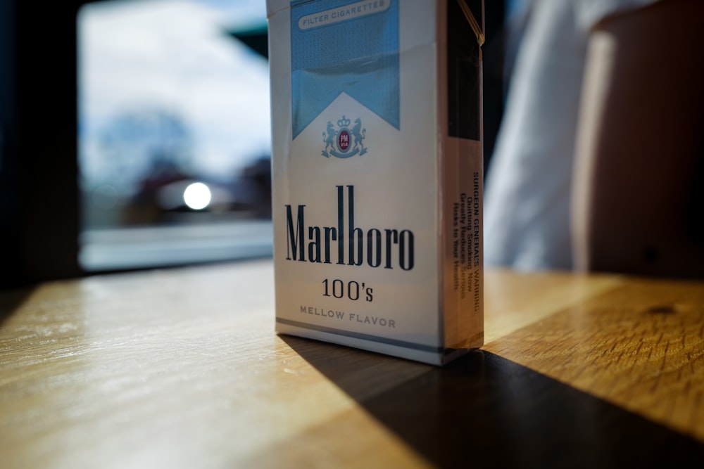 a box of marlboro sitting on top of a wooden table