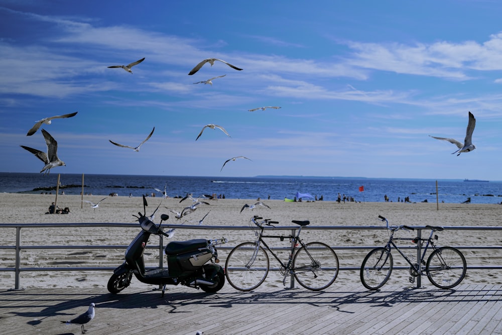 a group of bikes parked next to each other on a beach