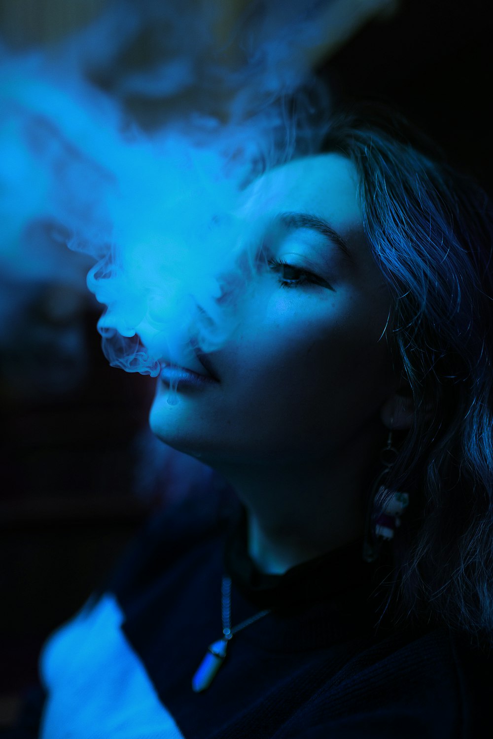 Eine Frau, die im Dunkeln eine Zigarette raucht
