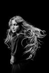 a black and white photo of a woman with long hair