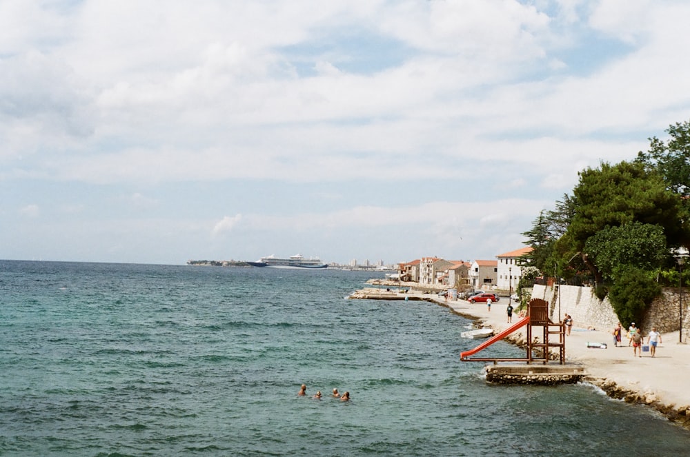 a body of water with people swimming in it