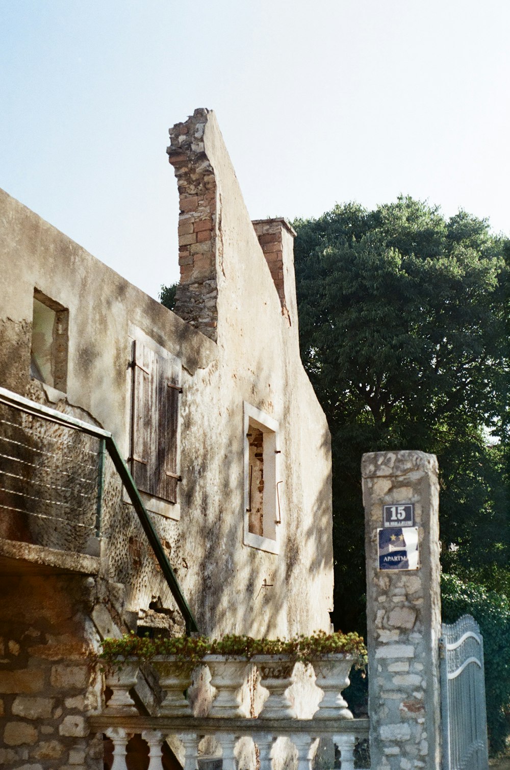 a stone building with a gate in front of it