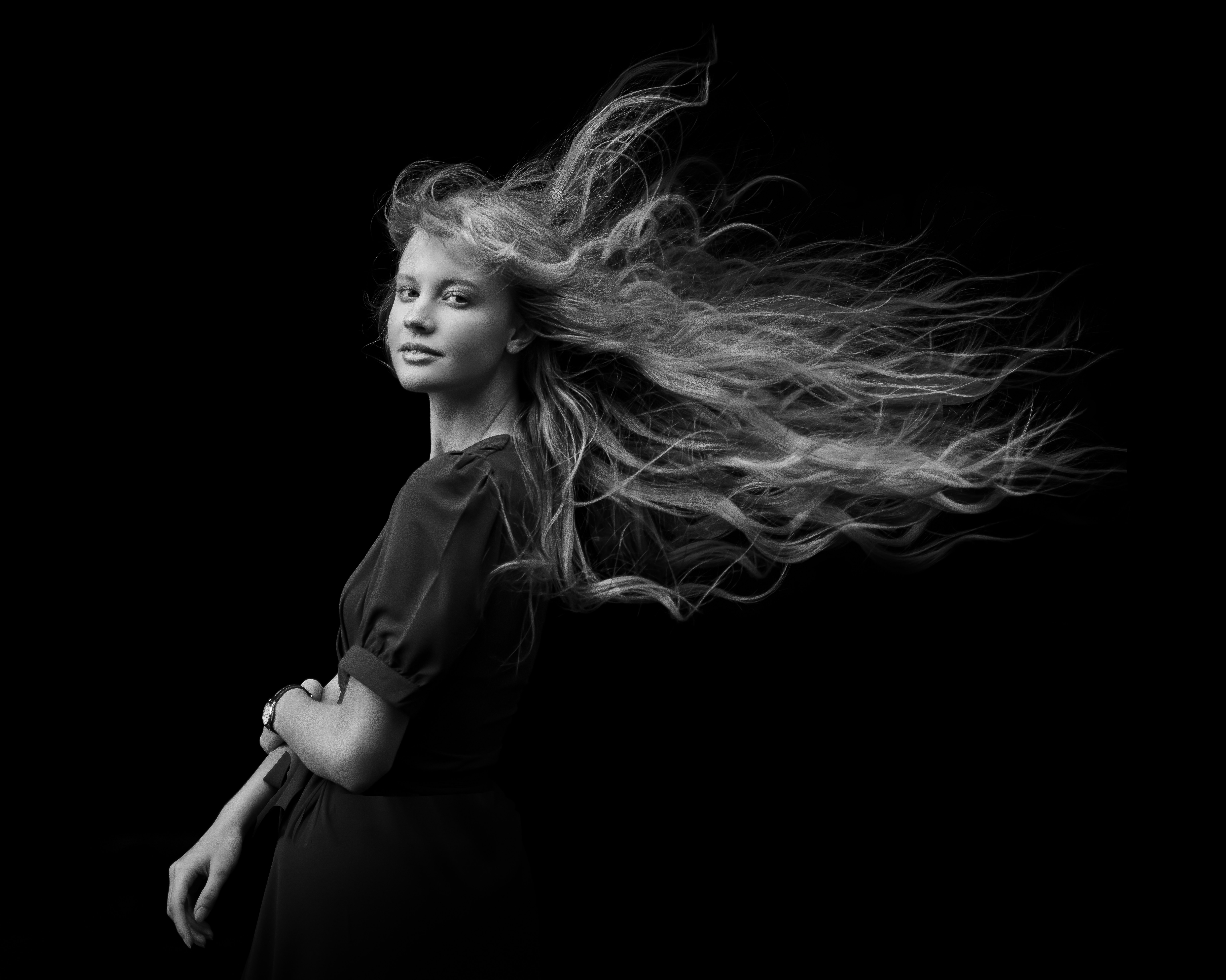 a woman with her hair blowing in the wind