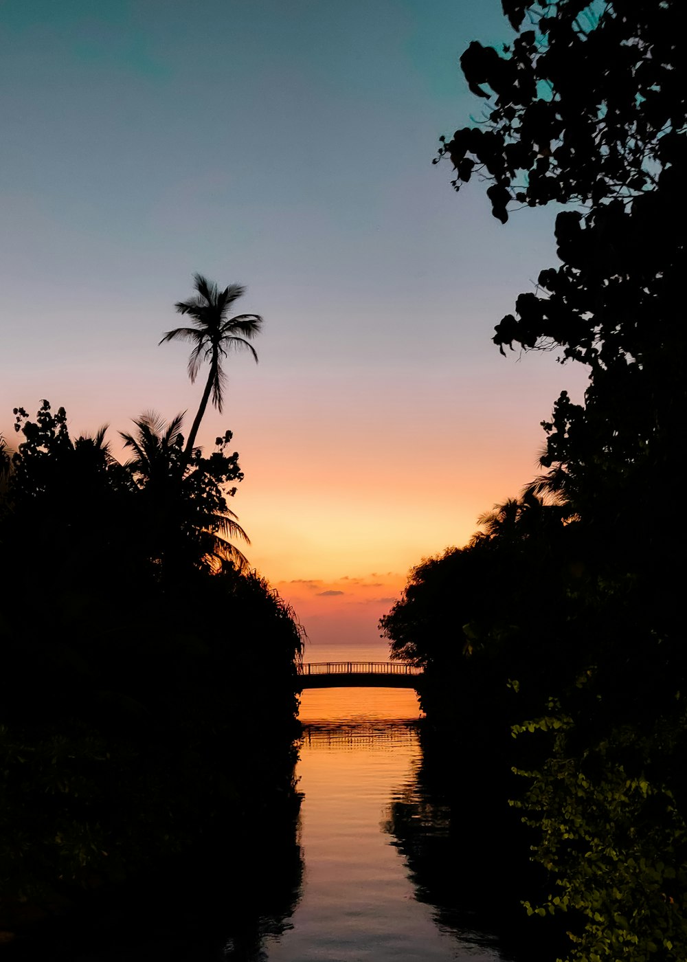 the sun is setting over a body of water