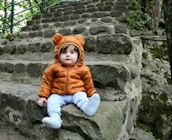 a small child sitting on some steps