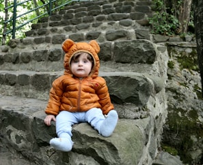 a small child sitting on some steps