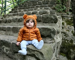 a small child sitting on some steps
