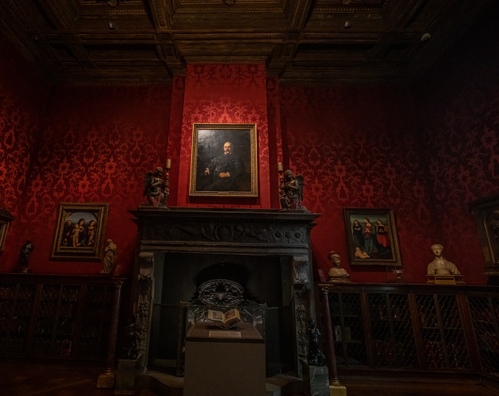 a room with red walls and a painting on the wall