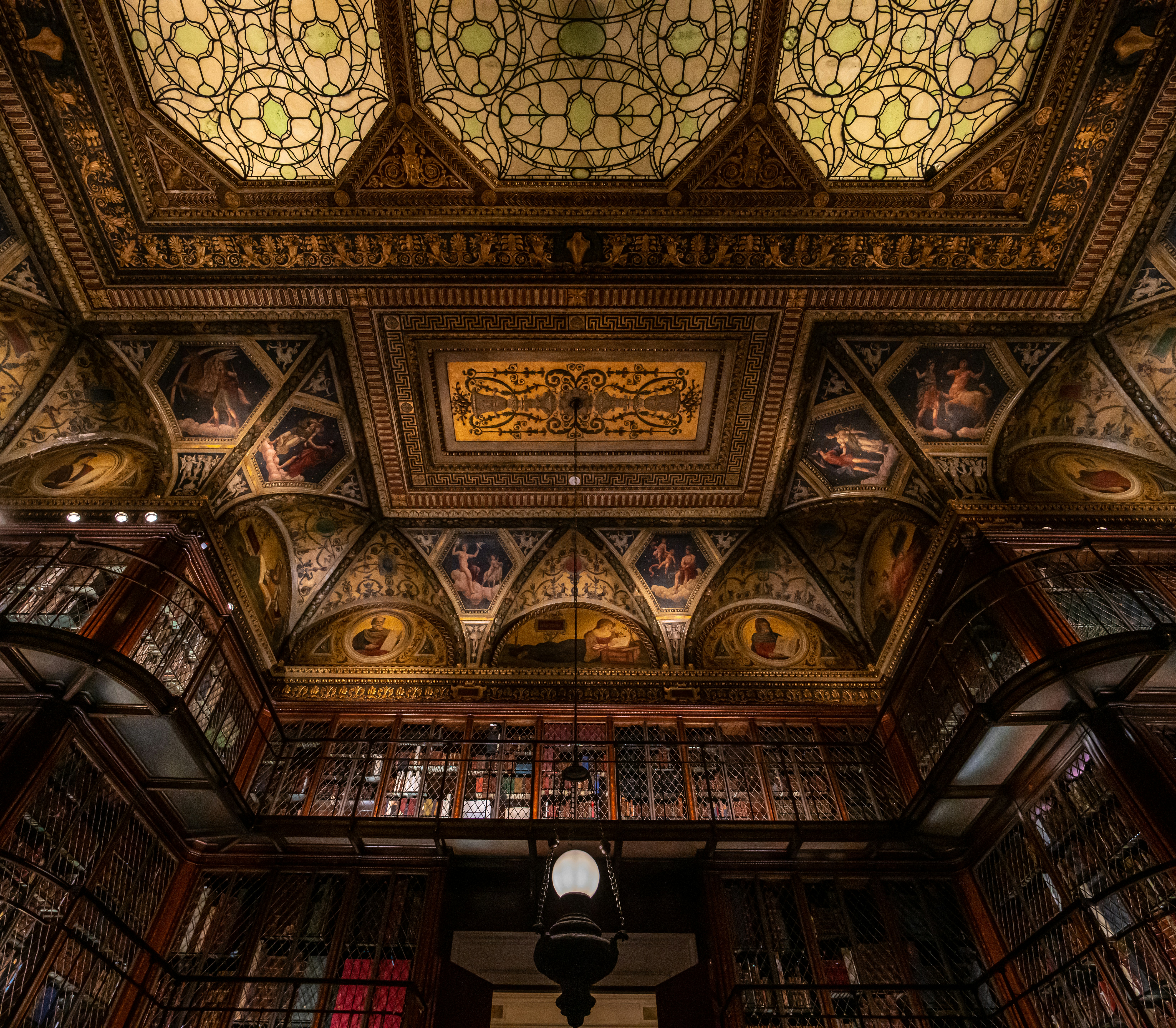 the ceiling of a library filled with lots of books