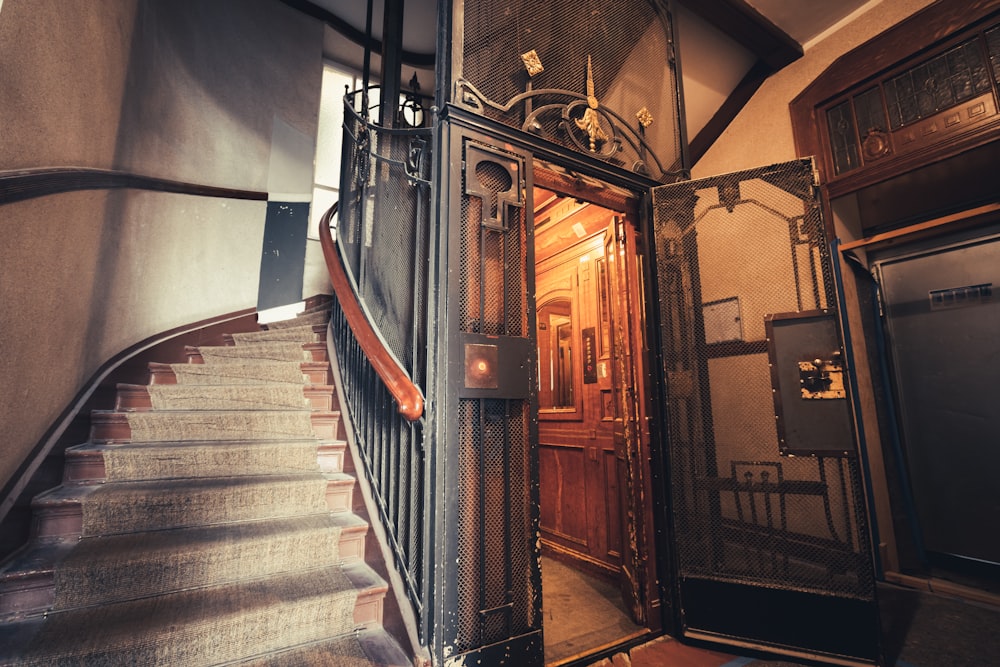 a staircase with a wrought iron door and railing
