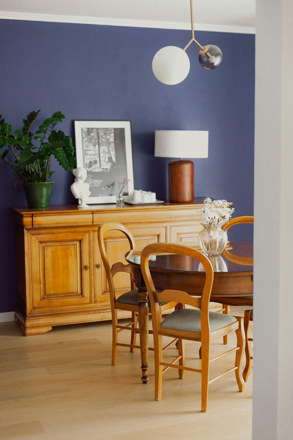 a dining room with blue walls and a wooden table