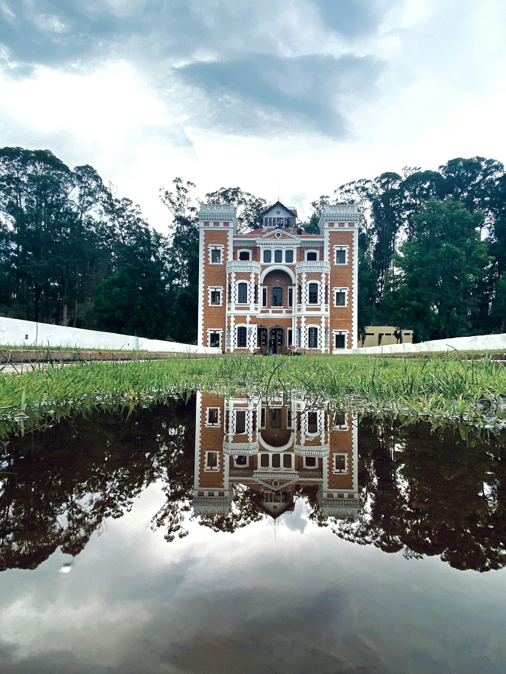 a reflection of a building in a body of water