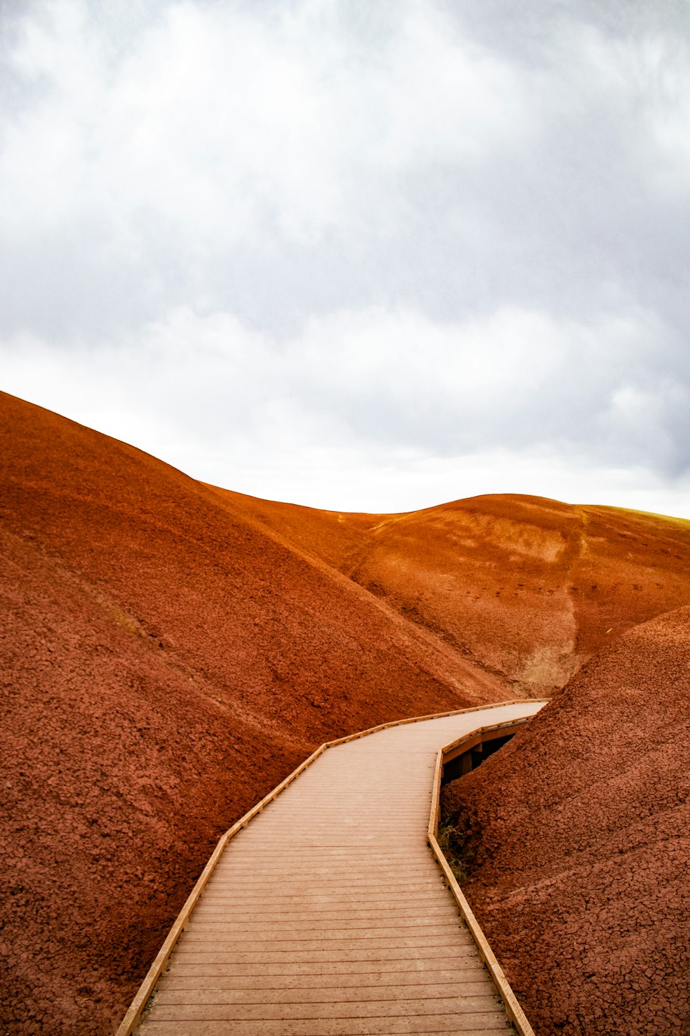 a wooden path going up a hill in the desert