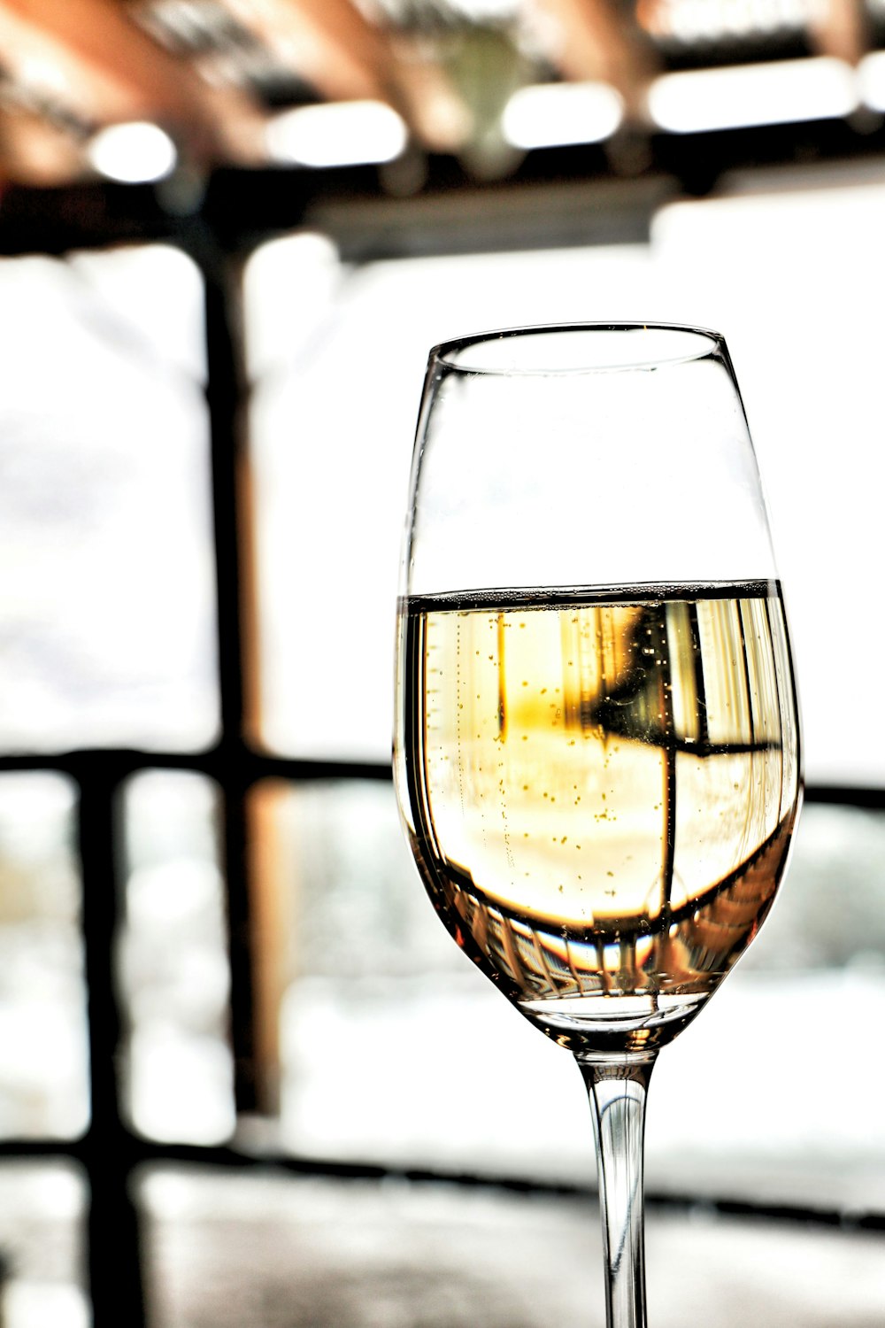 a glass of wine sitting on top of a table