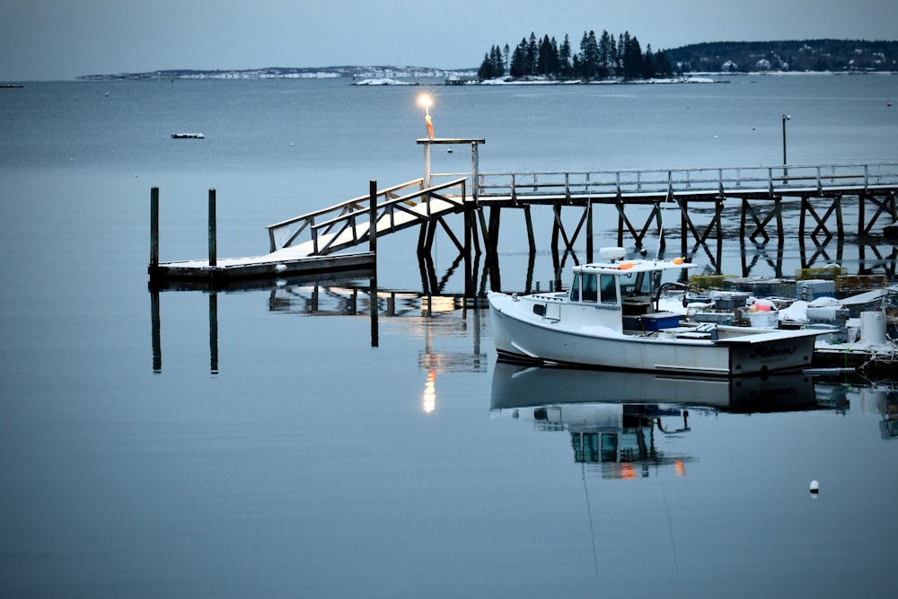 a small boat is docked at a pier