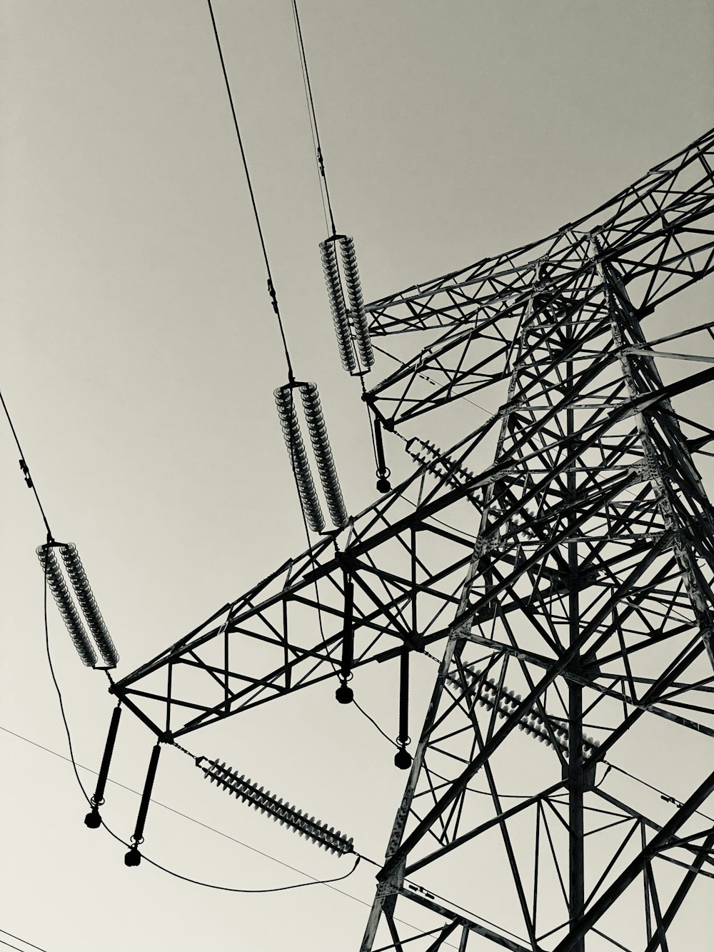 a black and white photo of a high voltage power line