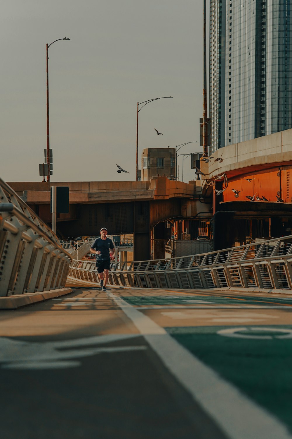a man running across a bridge in a city