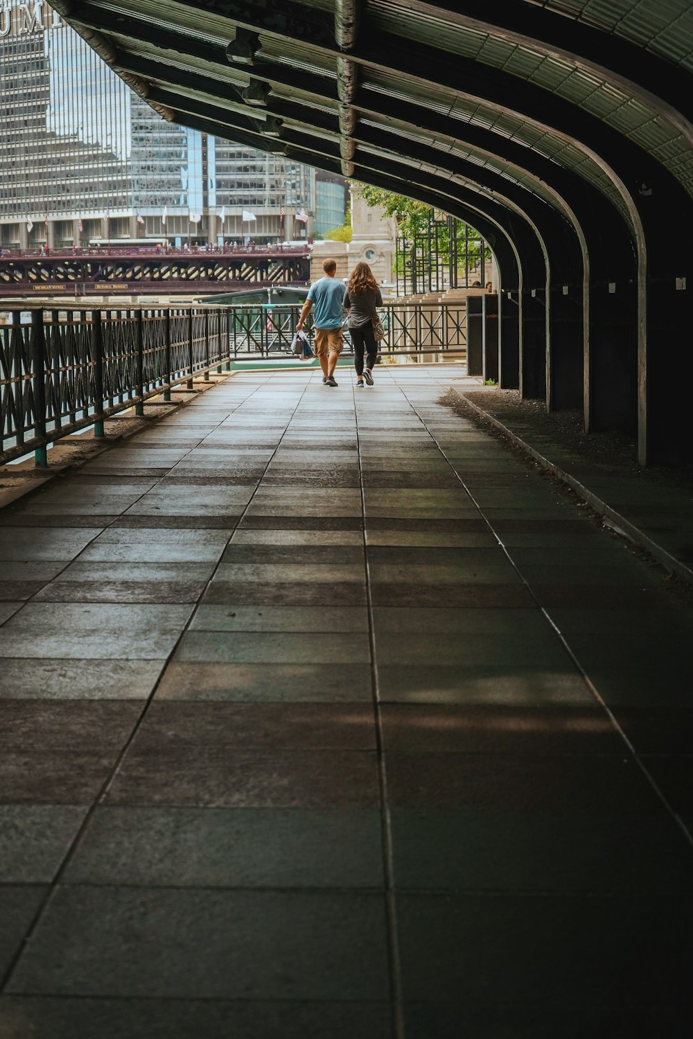 a couple of people walking down a walkway