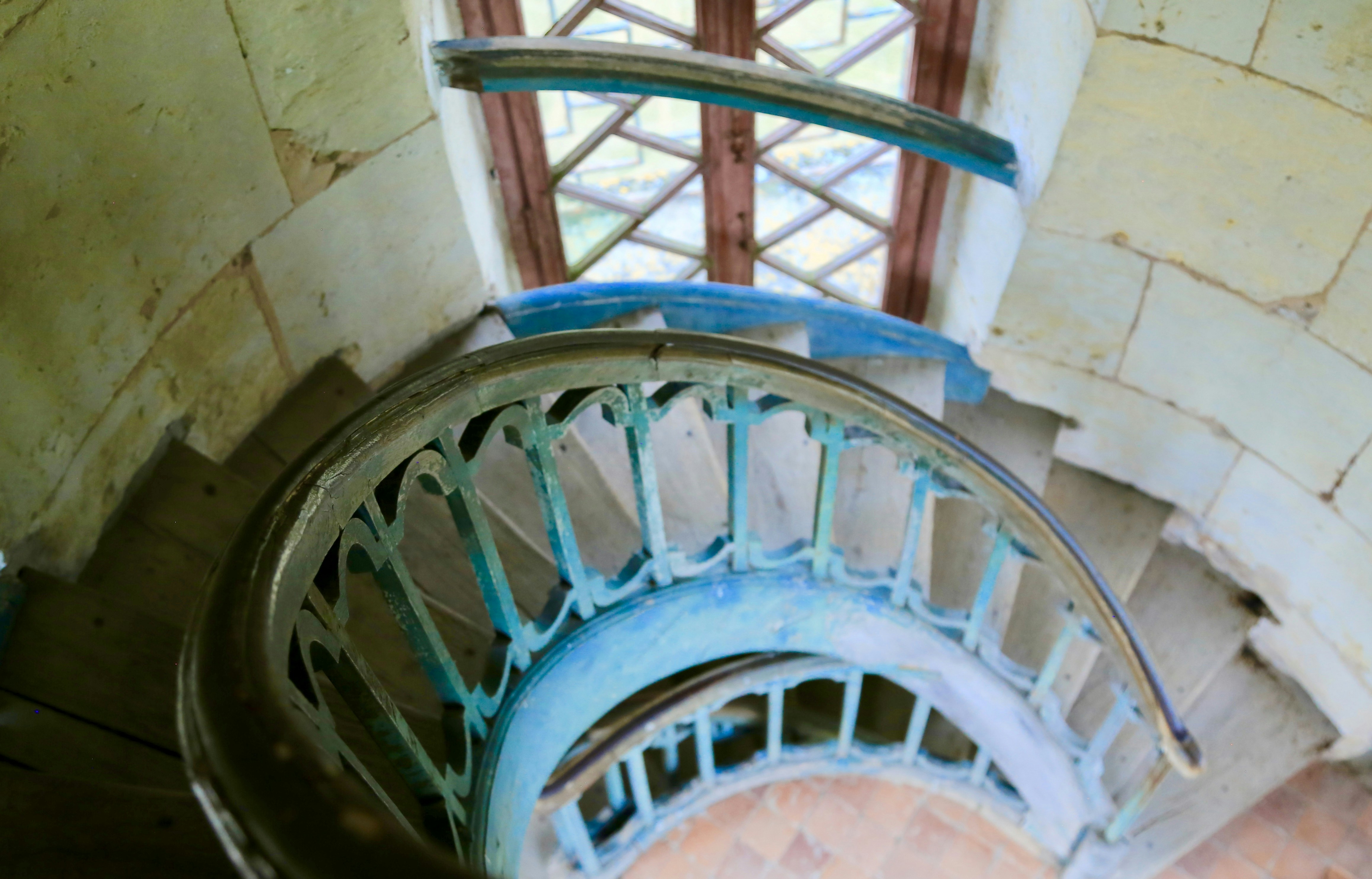 a spiral staircase in a building with a window