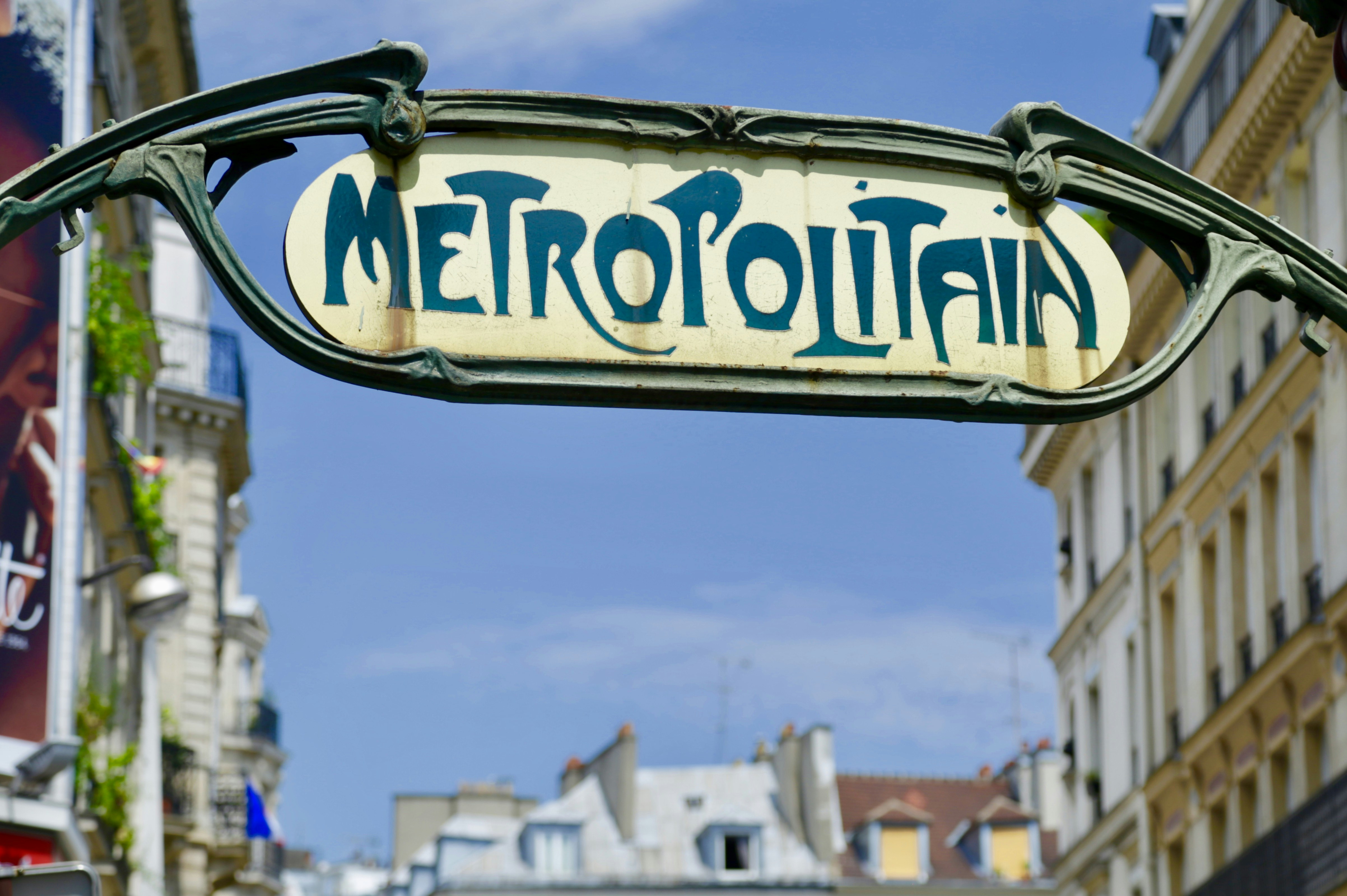 a close up of a street sign with buildings in the background