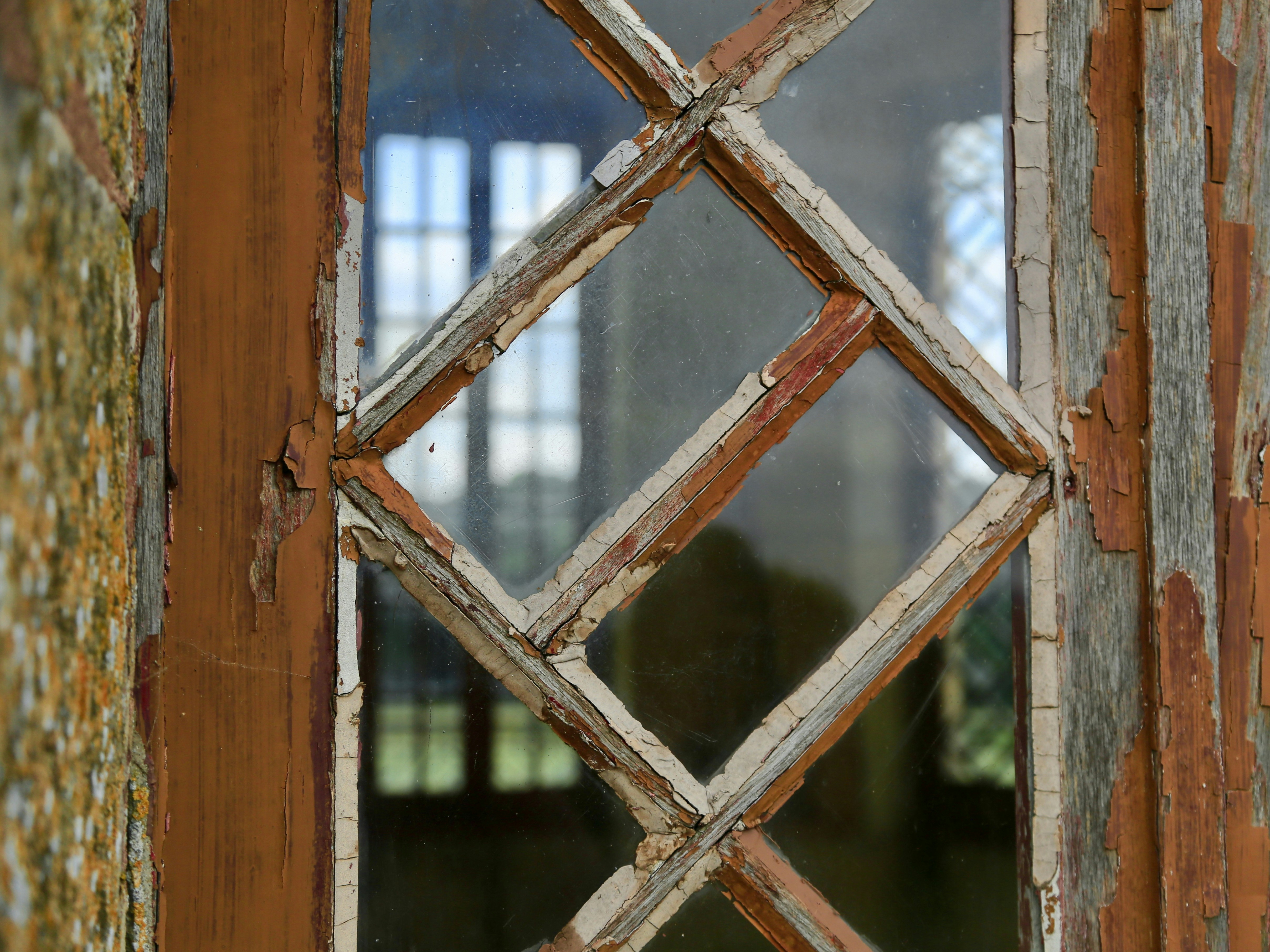 Close-up of a rotting wooden window frame needing replacement - home window installation near me