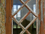Before-and-after shot of a weathered window frame replaced with new glass.