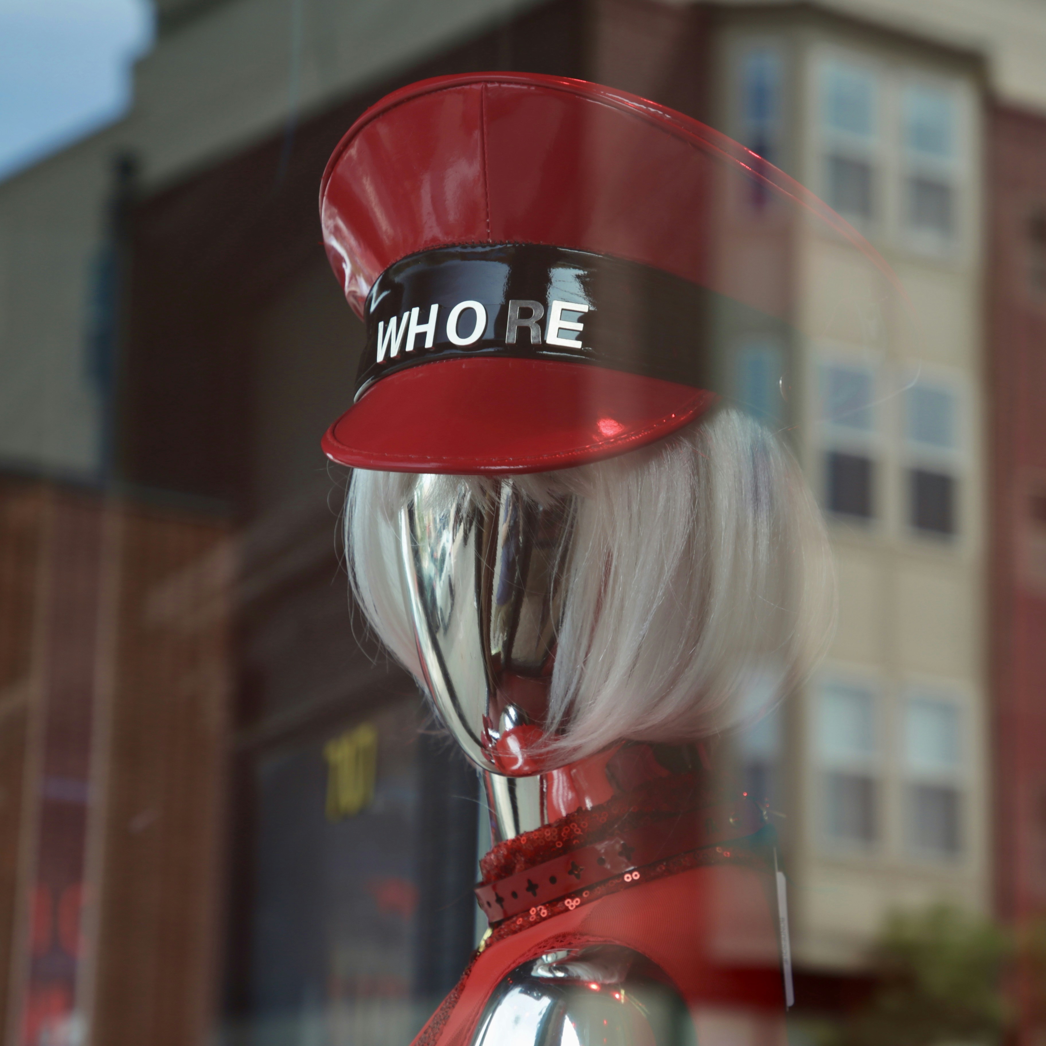 a close up of a mannequin wearing a red hat