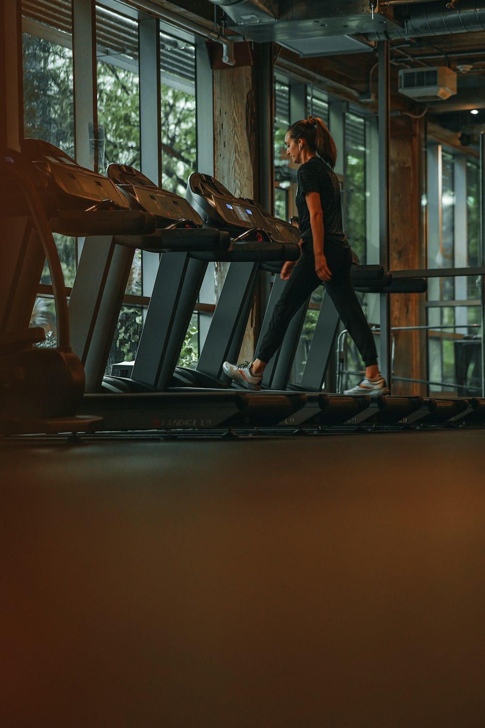 a woman running on a treadmill in a gym