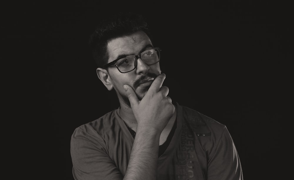 a black and white photo of a man with glasses