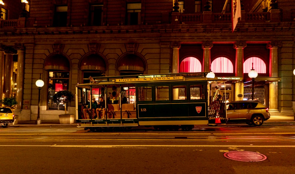 a trolley car on a city street at night