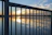 Close-up of a sleek custom metal railing with warm sunset lighting.
