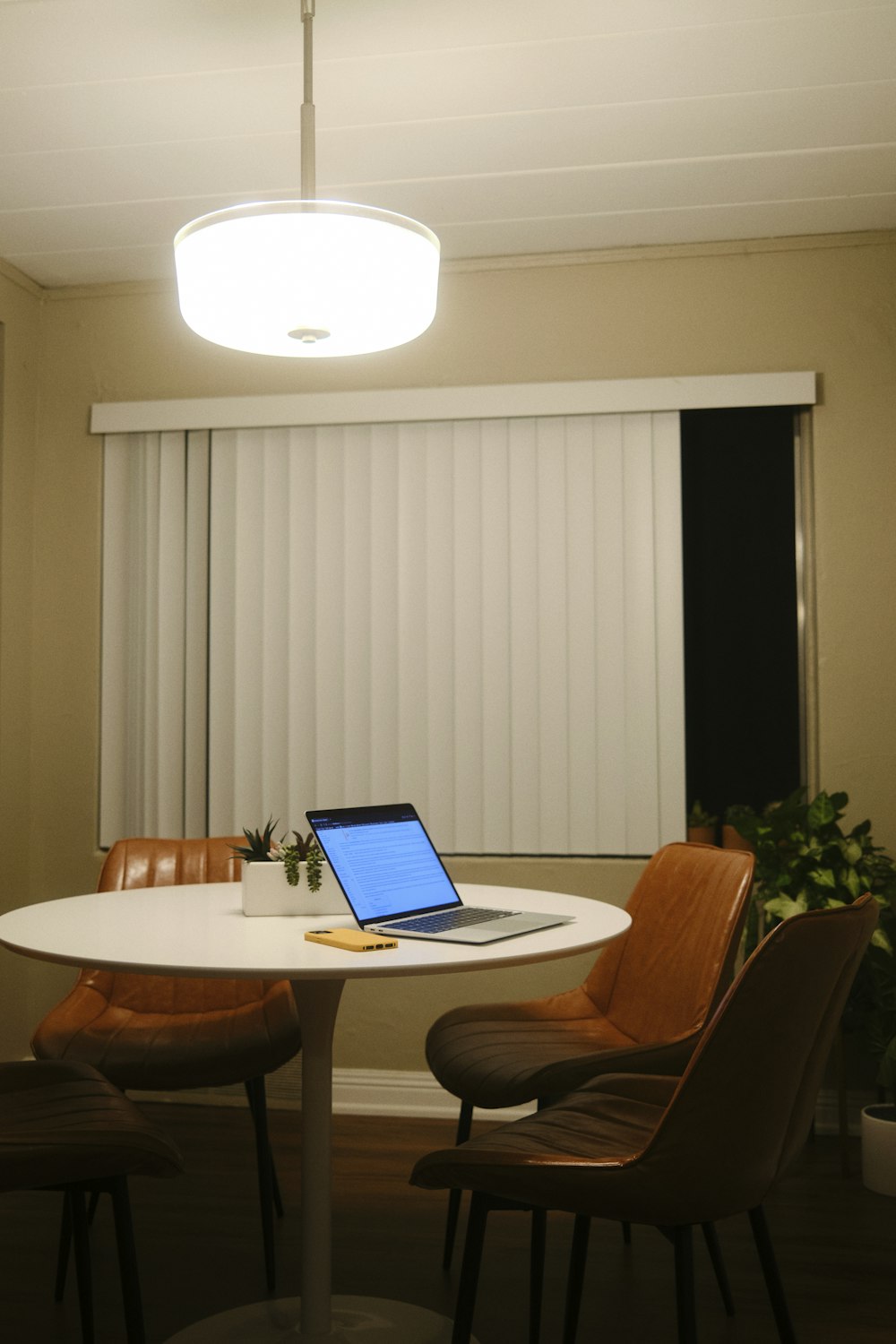 a laptop computer sitting on top of a white table