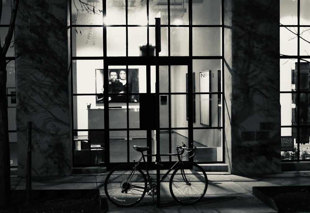 a bicycle is parked in front of a building