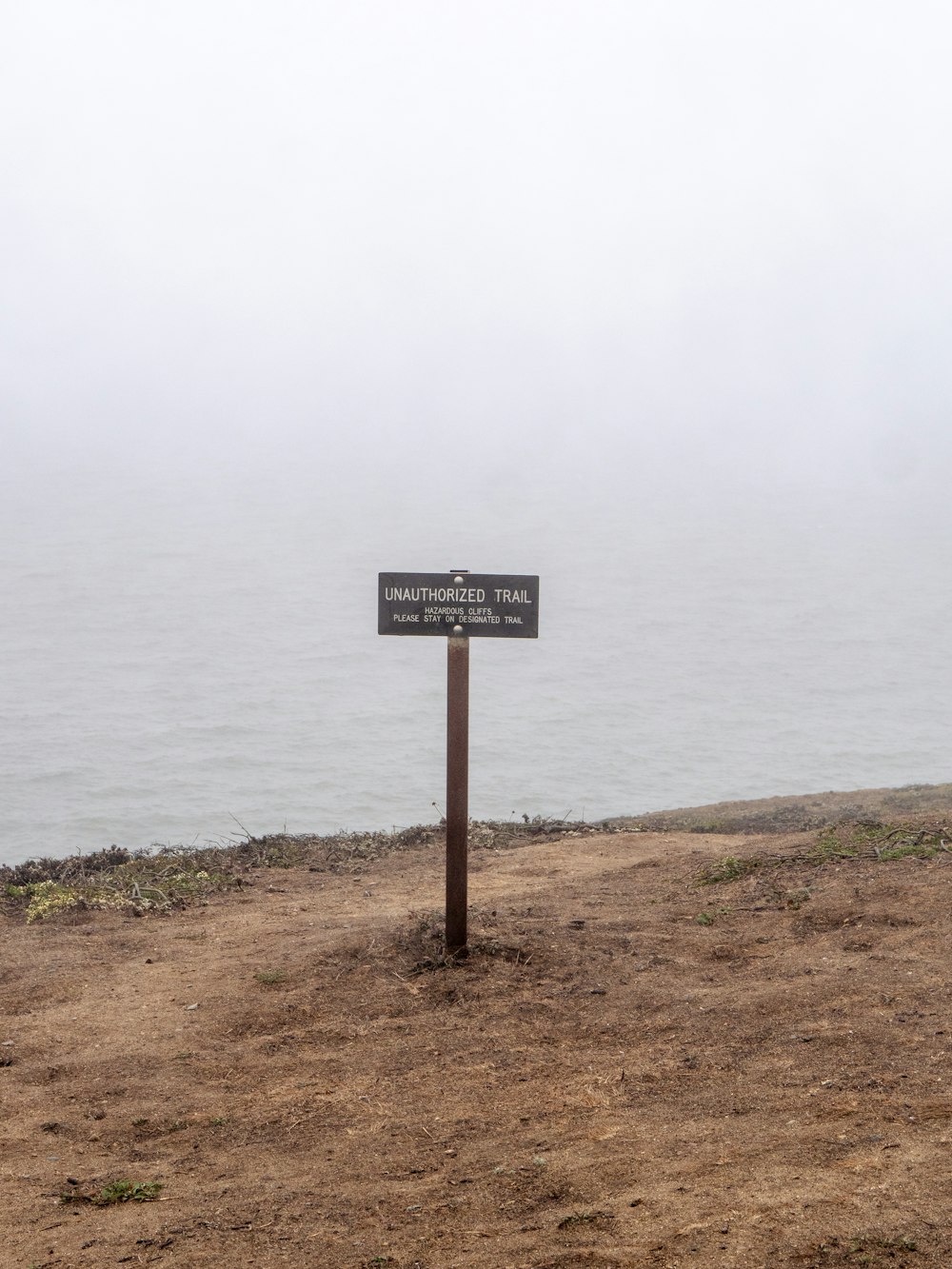 a sign that is on the side of a hill