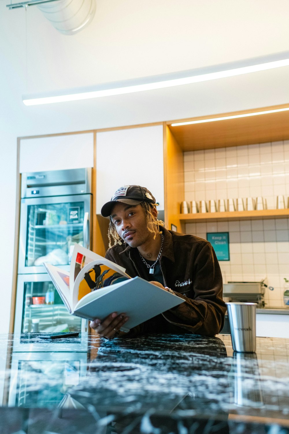 a man sitting at a counter reading a book