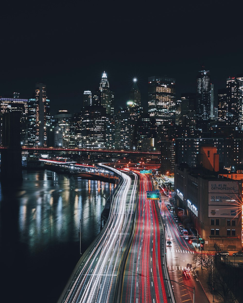 a night time view of a city with a river running through it