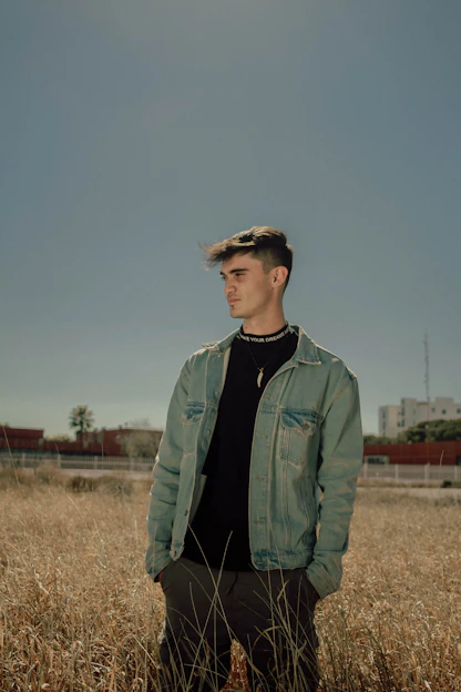 a man standing in a field of tall grass