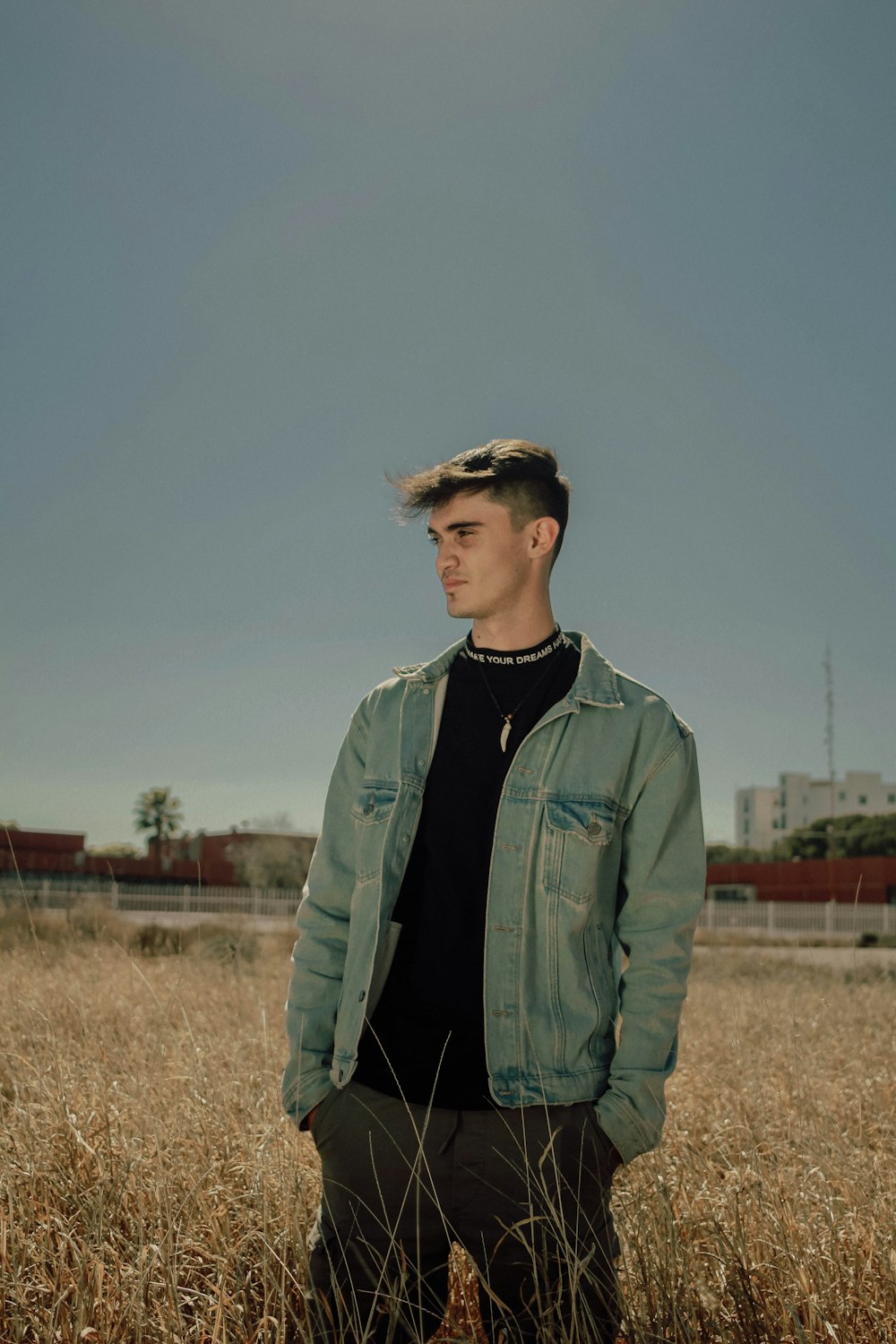 a man standing in a field of tall grass