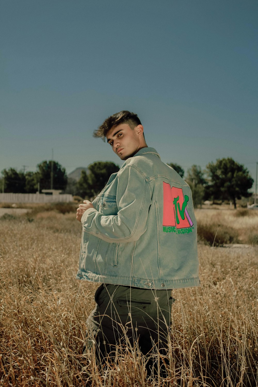 a man standing in a field of tall grass