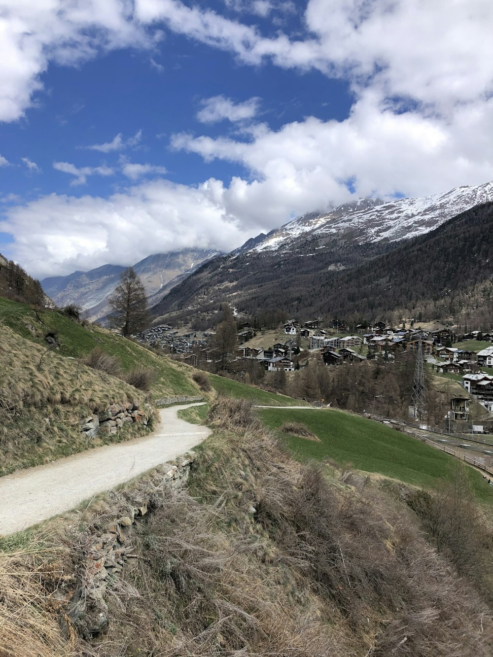 a scenic view of a small town in the mountains