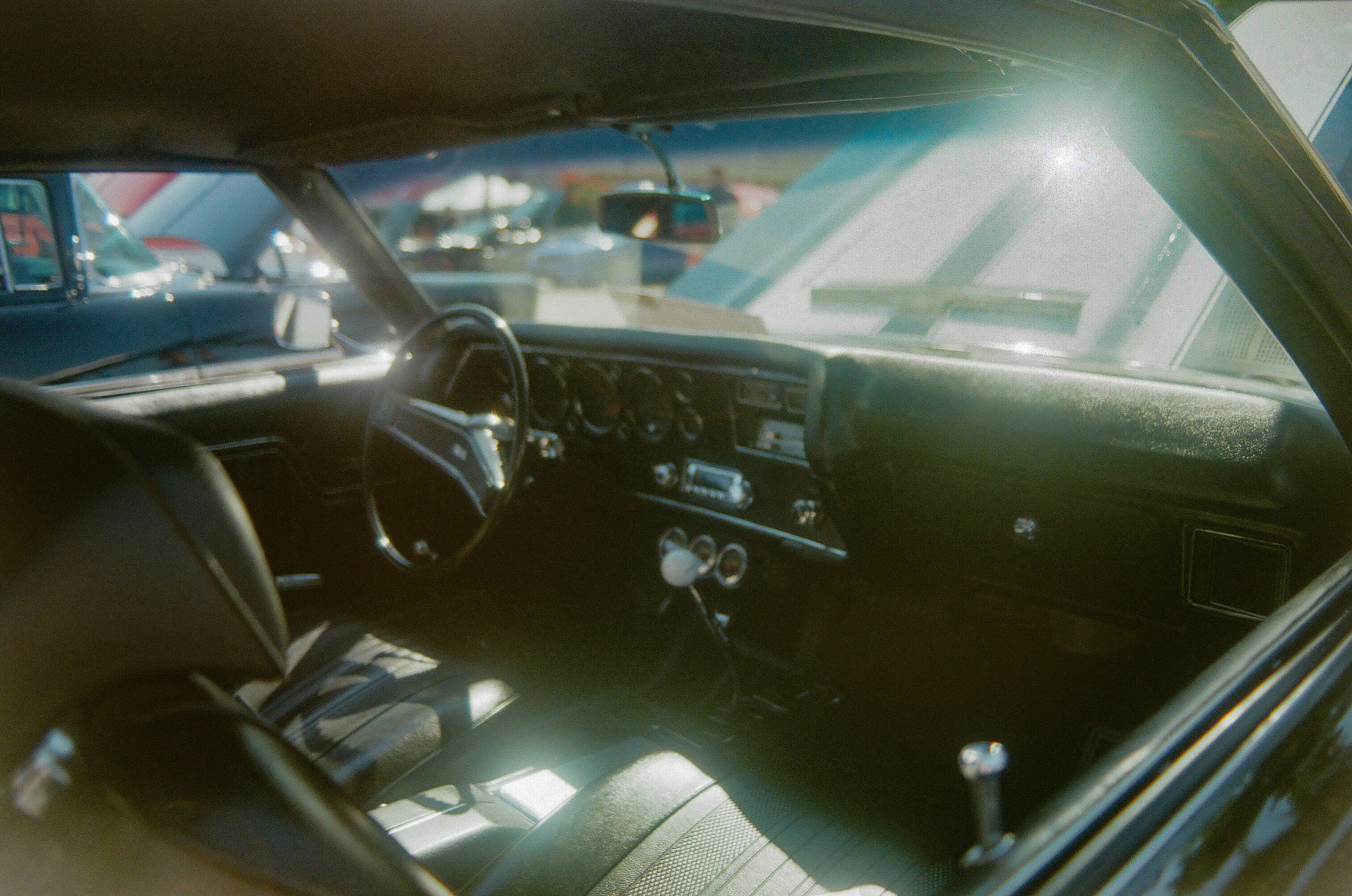 the interior of a car with the sun shining through the windshield