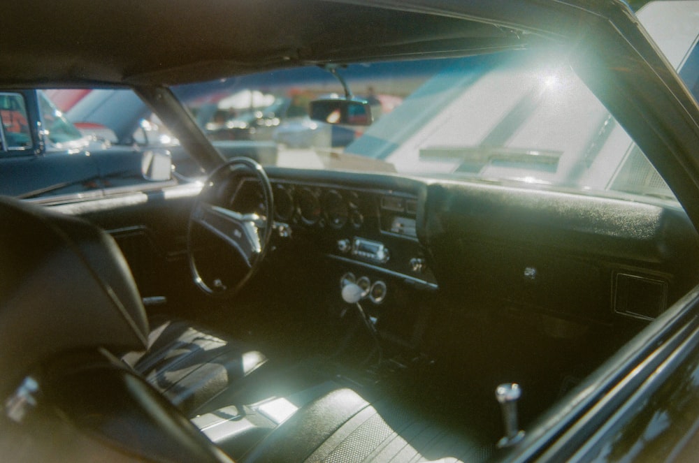 the interior of a car with the sun shining through the windshield
