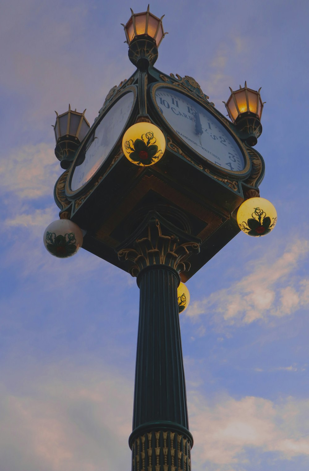 a clock on a pole with a sky in the background