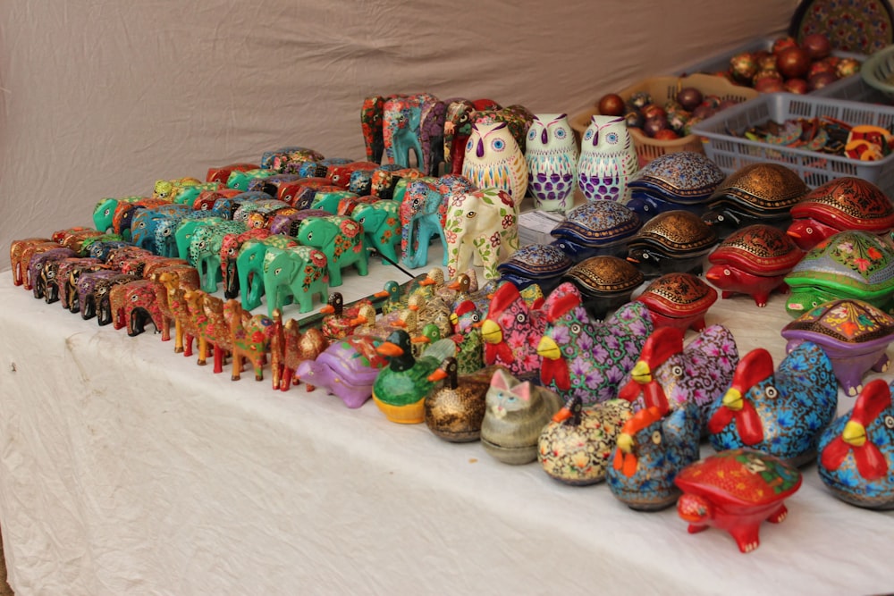 a table topped with lots of colorful figurines