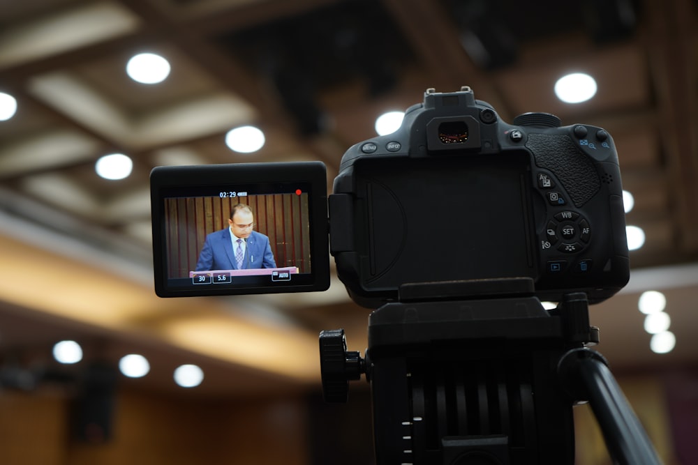 a video camera recording a man in a suit