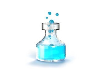 a bottle filled with blue liquid on top of a white surface