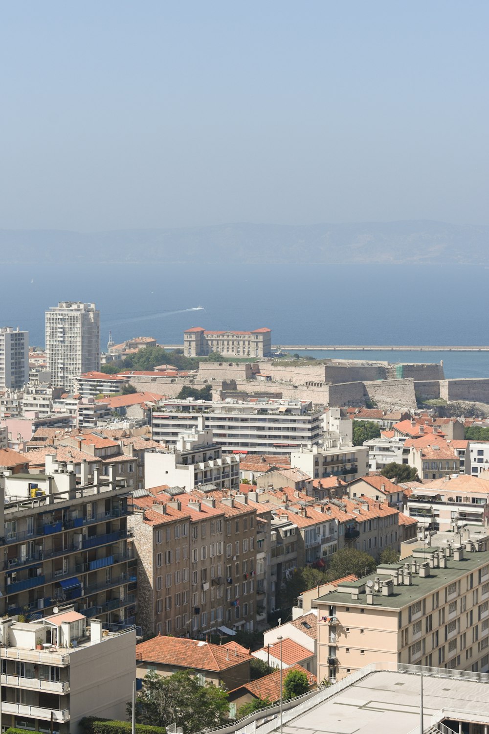 a view of a city with buildings and a body of water in the background