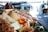 Fresh tropical fruits displayed neatly in wooden crates at a bustling outdoor market.