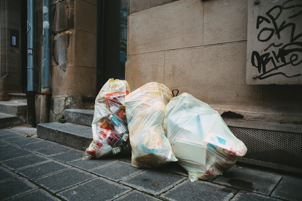 a pile of garbage sitting on the side of a building