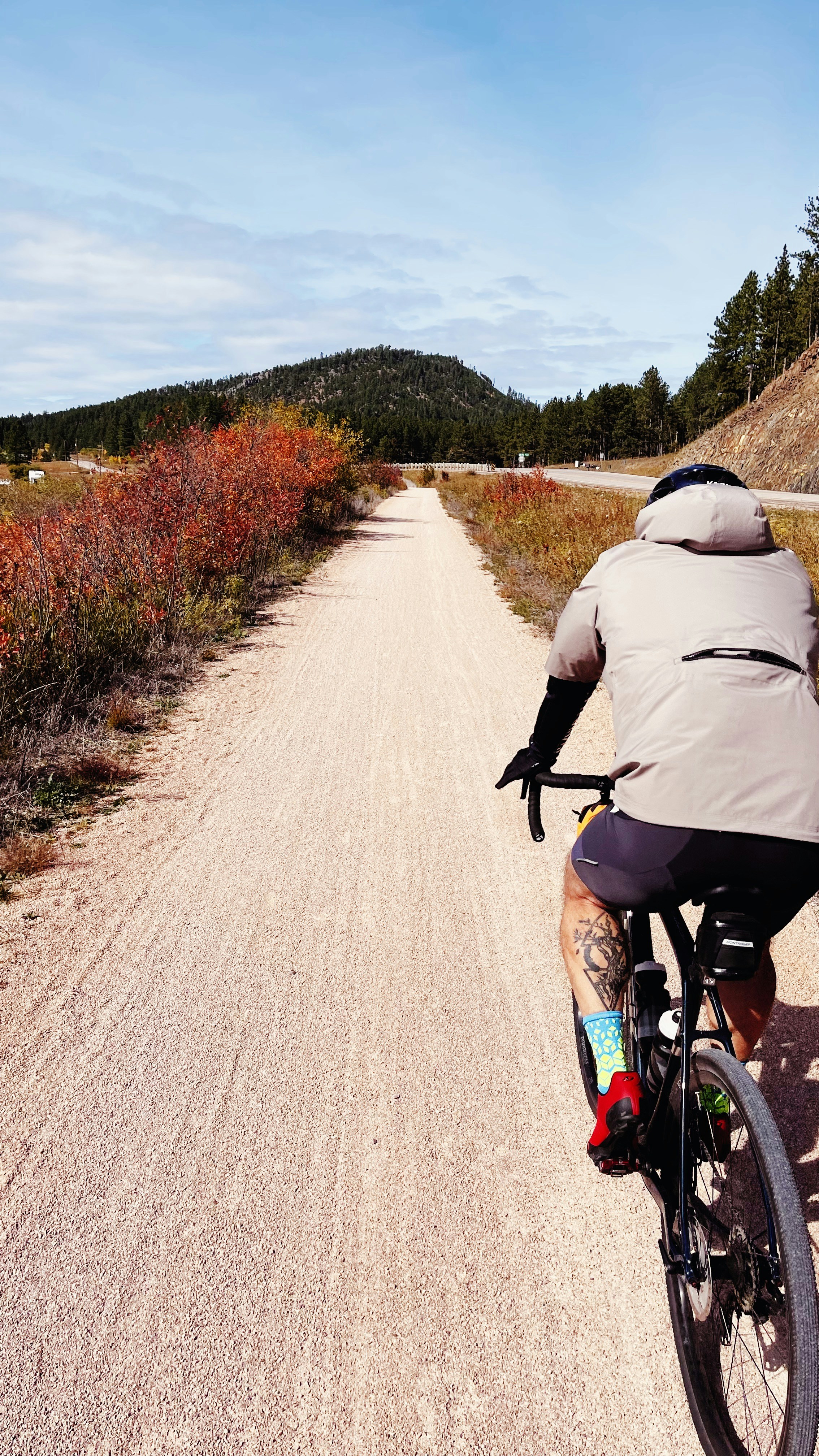 a man riding a bike down a dirt road